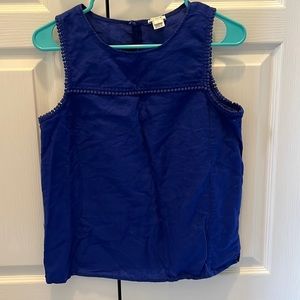 Sleeveless royal blue j crew top. Pom Poms around the sleeves and on top!